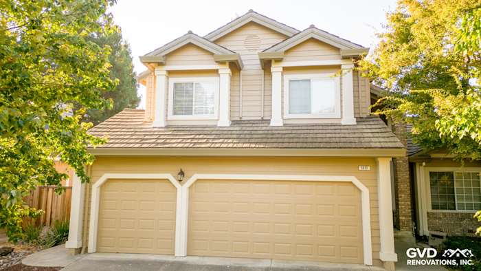 Home exterior featuring Khaki Brown James Hardie siding, Alside vinyl windows, and Cobble Stone HardieTrim boards in Santa