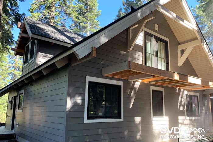Newly installed James Hardie siding in gray with wooden trim on a Tahoe City home exterior