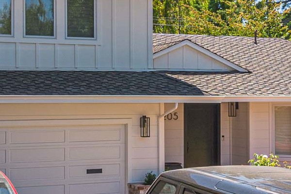 Menlo Park home exterior featuring James Hardie Batten Board siding and new landscape design with two parked vehicles