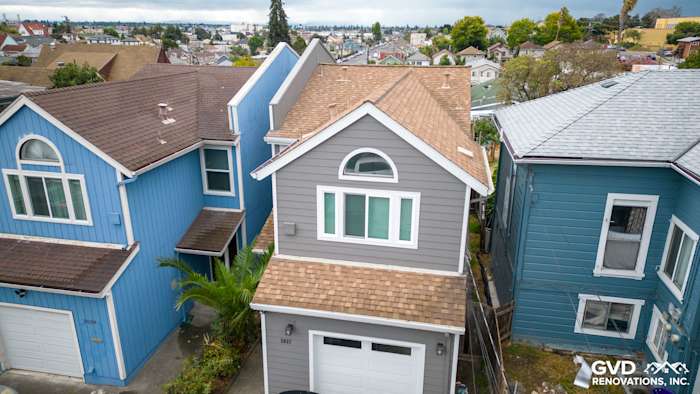 Oakland home showcasing Aged Pewter James Hardie siding and Arctic White HardieTrim among neighboring houses