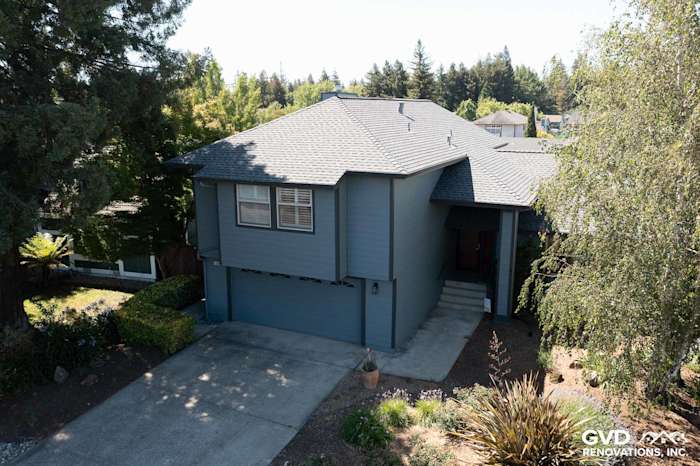 Home exterior featuring new Boothbay Blue James Hardie siding, Milgard windows, and landscaped yard in Rohnert Park