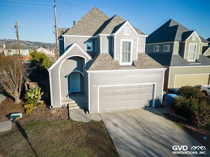 Modern home exterior featuring James Hardie Aged Pewter siding and a newly shingled roof in Santa Rosa