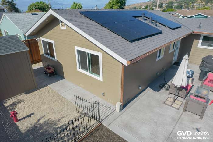 Coastal home exterior with Timber Bark siding, Arctic White trim, new Anlin windows, and solar panels in Pacifica