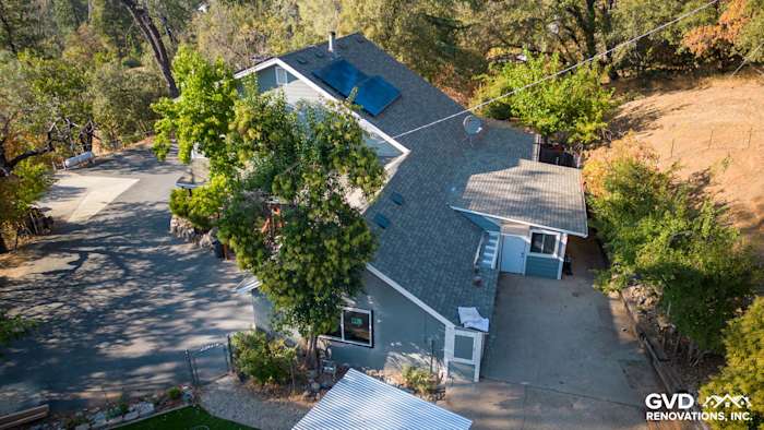 Home exterior in Colfax, CA featuring Gray Slate James Hardie siding and Arctic White trim surrounded by trees
