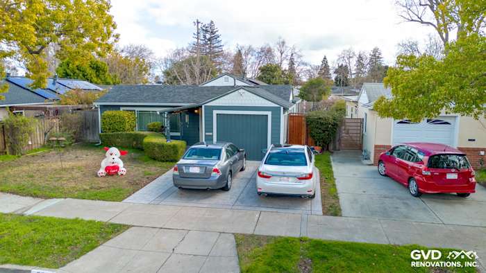 Home exterior remodel in Redwood City featuring James Hardie Evening Blue siding with Arctic White trim and driveway parking