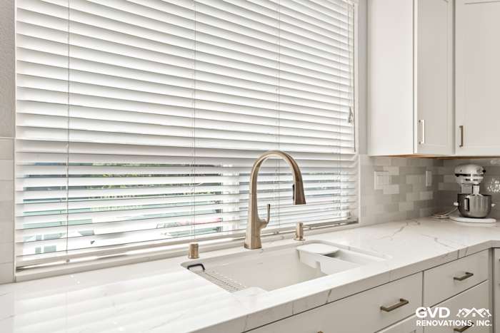 Sleek kitchen sink area with MSI countertops, modern faucet, and textured backsplash in Roseville kitchen remodel