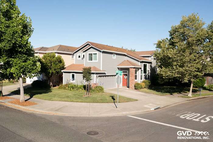 Home exterior featuring Gray Slate James Hardie siding and Arctic White trim, surrounded by landscaped yard in Petaluma