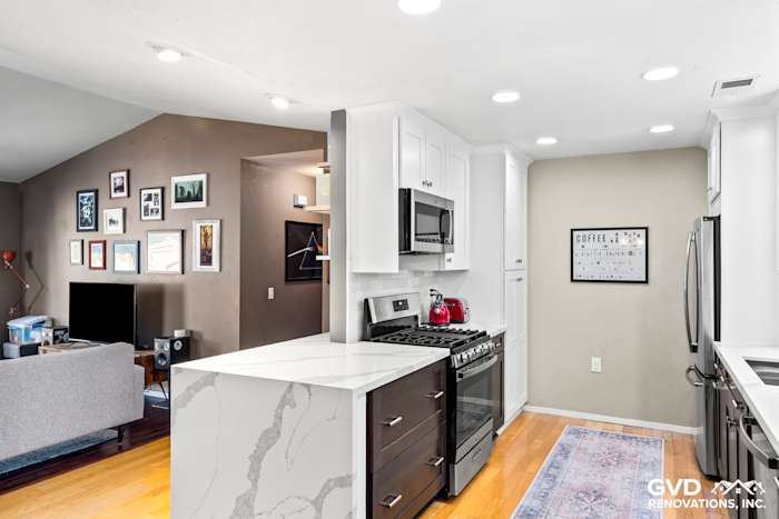 Modern kitchen remodel in Davis featuring white cabinets, quartz countertop, stainless steel appliances, and recessed