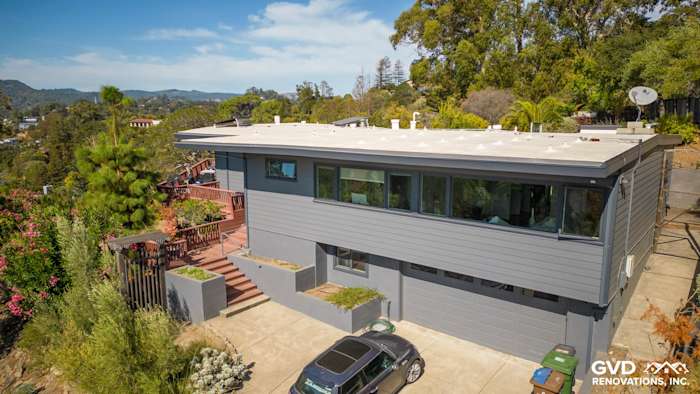 Modern home exterior featuring Night Gray James Hardie Plank Lap Siding in San Rafael, CA, surrounded by lush greenery