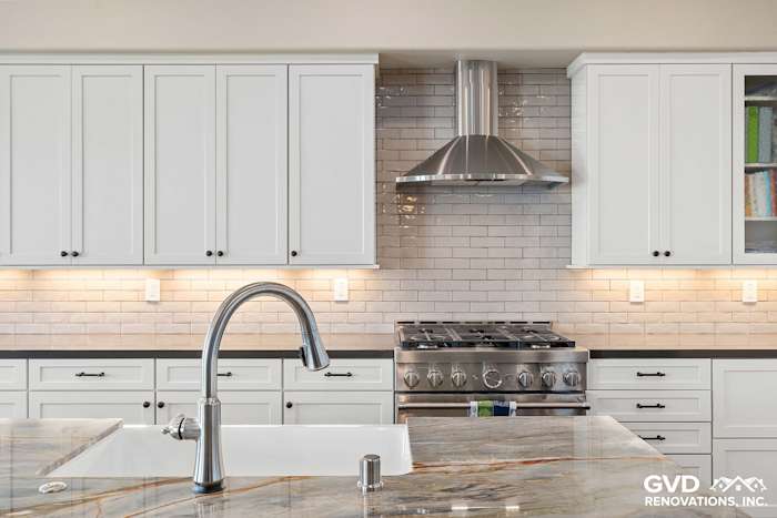 Modern kitchen featuring white cabinets, a marble countertop, and stainless steel appliances in El Dorado Hills