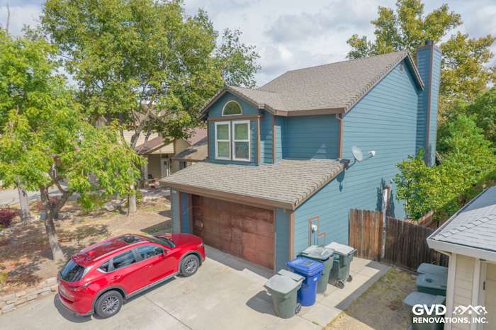 Home exterior in Antelope, featuring blue James Hardie siding, Anlin windows, and a red car in driveway