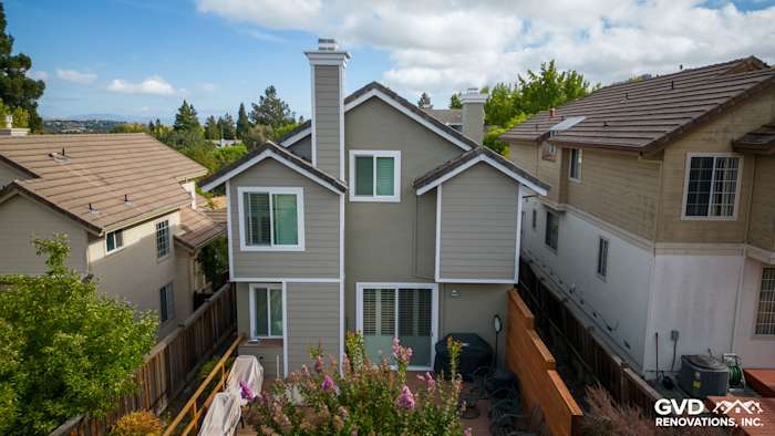 Home exterior in Danville showcasing Monterey Taupe James Hardie siding and Arctic White trim against a clear sky