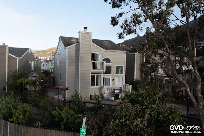 Daly City home featuring James Hardie Lap Siding in Monterey Taupe and Cobble Stone trim, surrounded by greenery