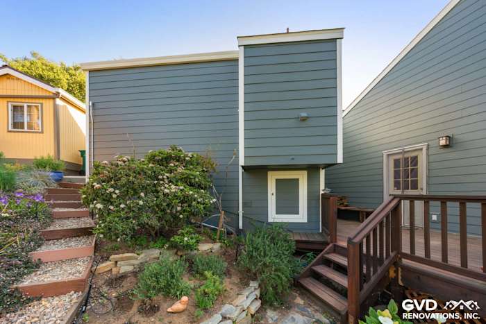 Stylish home exterior featuring James Hardie siding in blue-gray with landscaped garden in Oakland, CA