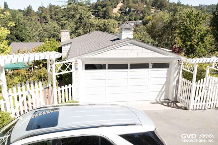 Orinda home featuring newly installed Pearl Gray James Hardie Shingle Siding and trim with a garage door