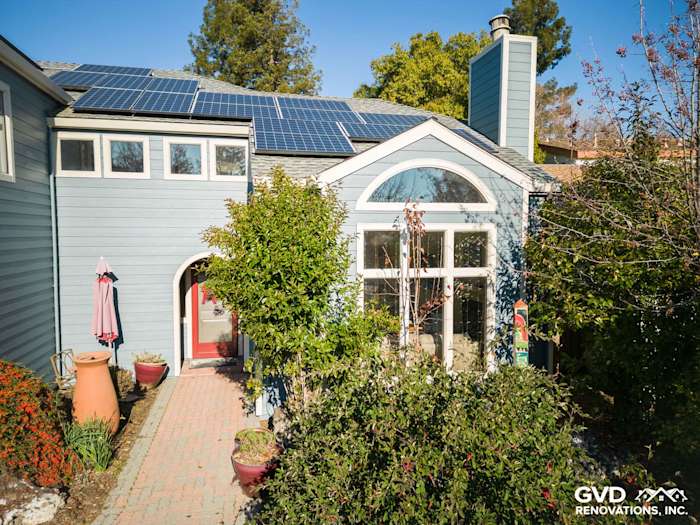 Home exterior featuring Boothbay Blue James Hardie siding, solar panels, and landscaped path in Davis, CA