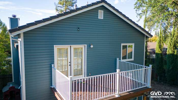 Folsom home's exterior featuring new blue Alside Prodigy vinyl siding and wooden deck with white railing