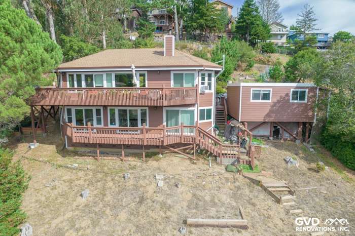 Mill Valley home with primed Hardie Lap Siding, Anlin Catalina Windows, and wooden deck overlooking hillside