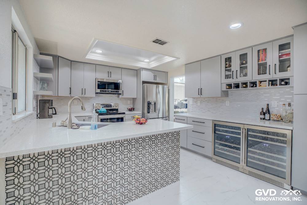 Modern kitchen remodel featuring sleek gray cabinetry, quartz countertop, and patterned backsplash in Sacramento