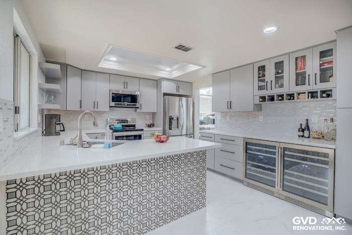 Modern kitchen remodel featuring sleek gray cabinetry, quartz countertop, and patterned backsplash in Sacramento