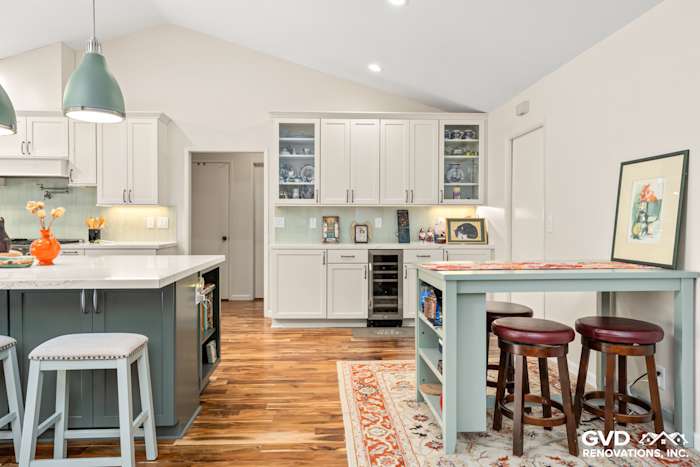 Modern kitchen remodel in Carmichael featuring custom island cabinets, stylish backsplash, and open layout with wood flooring