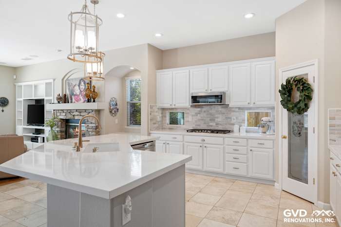 Modern kitchen remodel featuring white cabinetry, quartz countertops, and mosaic tile backsplash in Sacramento
