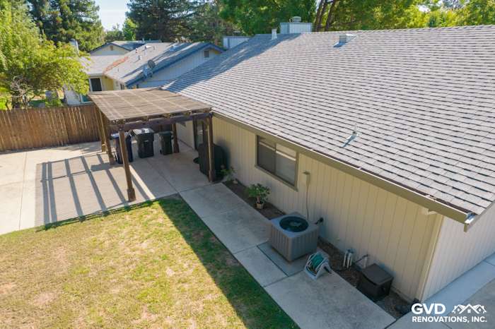 Aerial view of a renovated home exterior in Sacramento with new James Hardie siding and a patio area