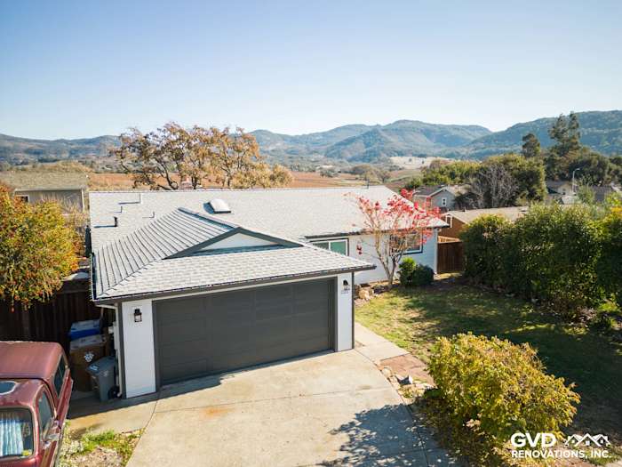 Single-story home exterior in Napa, CA with Arctic White James Hardie siding and mountain backdrop