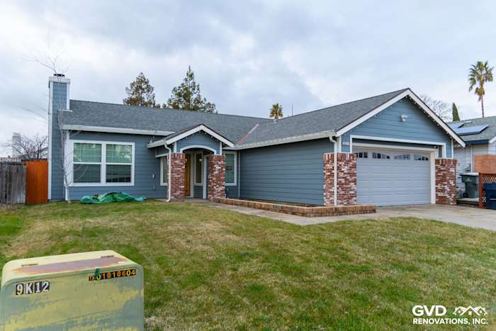 Home exterior featuring Boothbay Blue James Hardie siding, Arctic White trim, and new brick accents in Sacramento