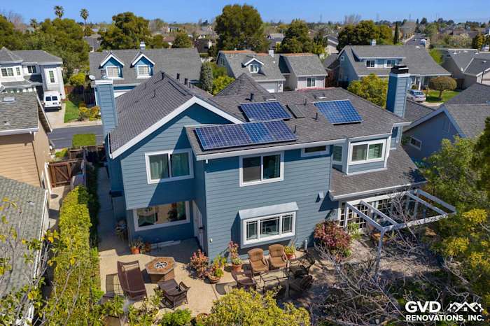 Two-story home exterior featuring Boothbay Blue Hardie Siding, Arctic White Trim, and solar panels in Foster City