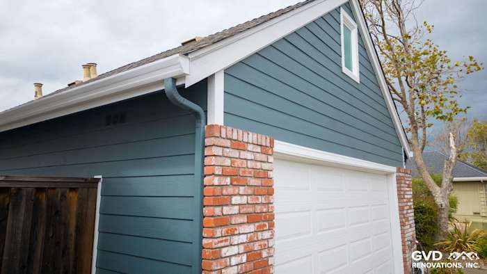 Evening Blue HardiePlank siding with Arctic White trim, featuring a garage and brick accents in Alameda, CA
