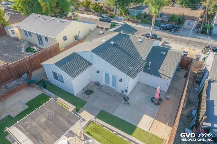 Aerial view of a Concord home featuring Arctic White James Hardie vertical siding and gray roofing