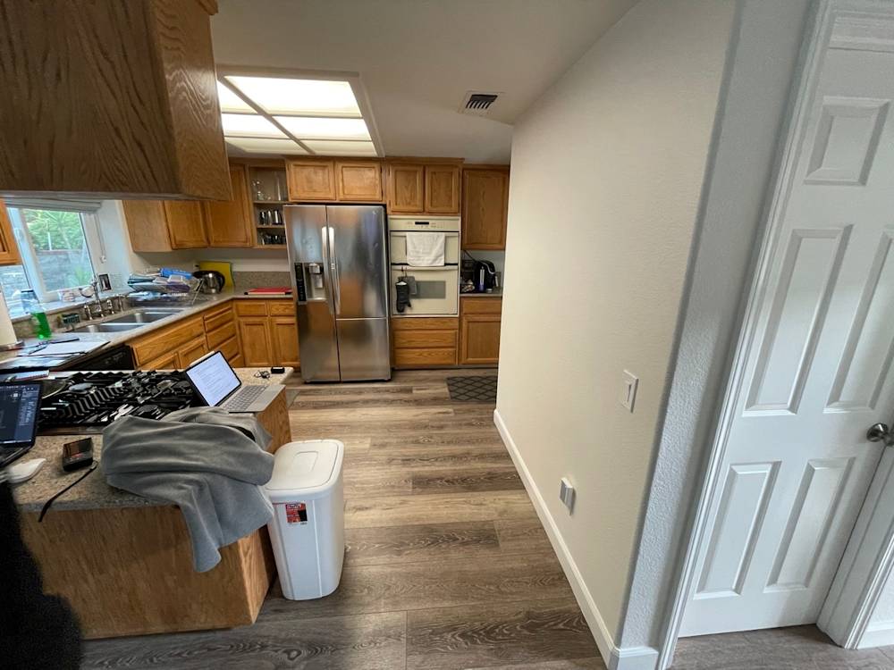 Compact Rocklin kitchen with oak cabinetry, stainless appliances, and light wood flooring