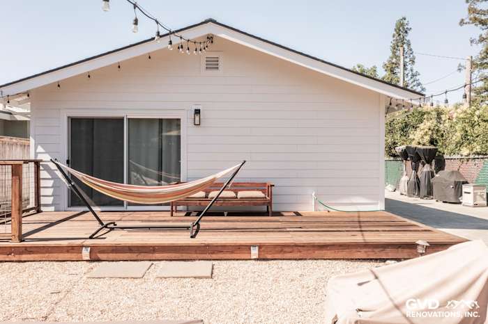 Updated home exterior featuring James Hardie Board & Batten siding, modern deck, and hammock in Novato, CA