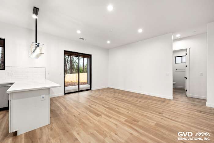 Spacious open-concept living area with high ceilings, large windows, and modern wood flooring in Paradise, CA