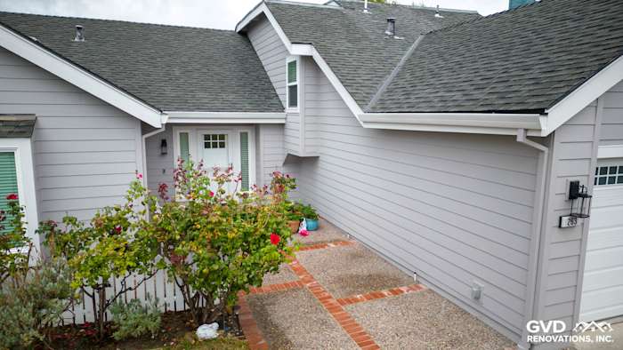 New Pearl Gray James Hardie siding and Milgard windows enhance the home's exterior in Foster City