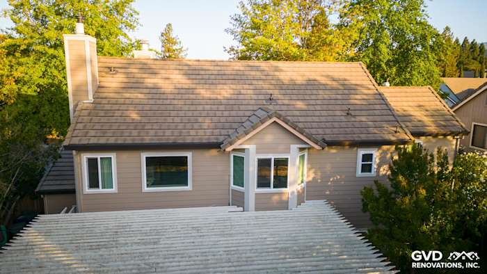Sonoma home featuring James Hardie Cedarmill siding and Alside vinyl windows, surrounded by green trees