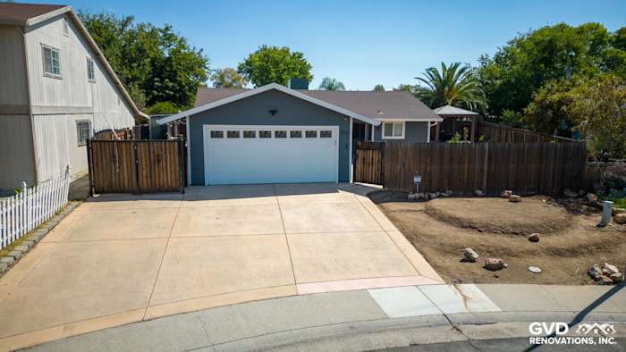 Home exterior featuring James Hardie Lap Siding in Night Gray and Arctic White trim, with a newly paved driveway