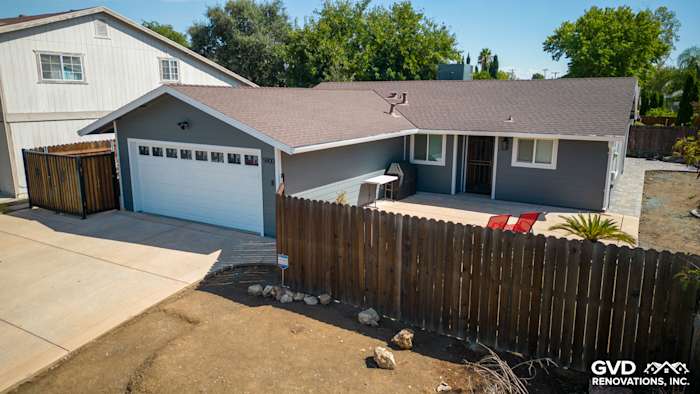 Home exterior featuring James Hardie Night Gray siding and Arctic White trim, with a newly updated garage and landscaping