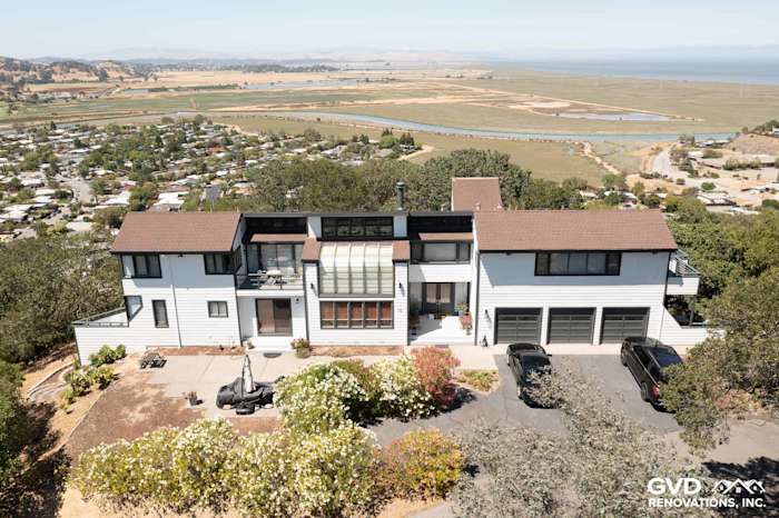 Modern home exterior in San Rafael featuring Arctic White James Hardie Siding and brown roof. Landscape and bay view