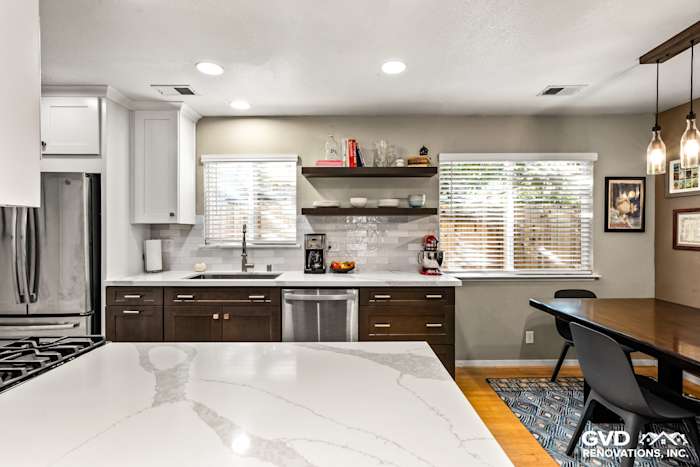 Modern kitchen remodel in Davis featuring a quartz countertop, dark wood cabinets, and open shelving