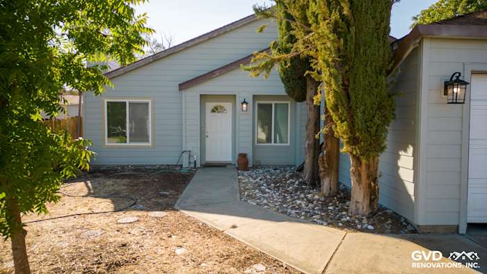 Home exterior featuring freshly installed James Hardie siding, landscaped area, and welcoming entrance in Sacramento