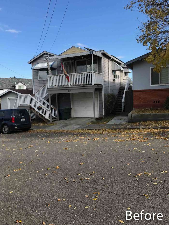 Before photo of a house in Rio Vista with old siding, covered porch, and a concrete driveway