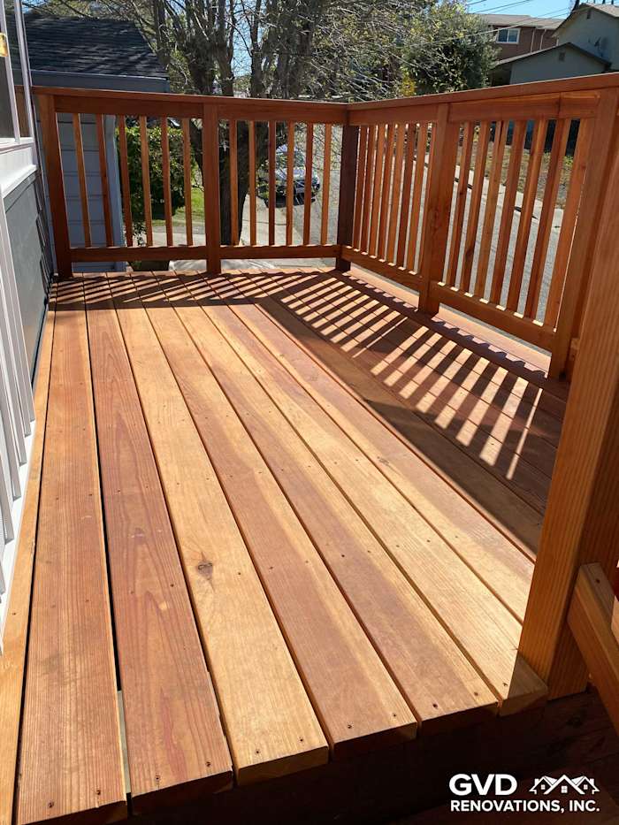 New wooden deck featuring expansive planks and railing steps, updated in Rio Vista, CA
