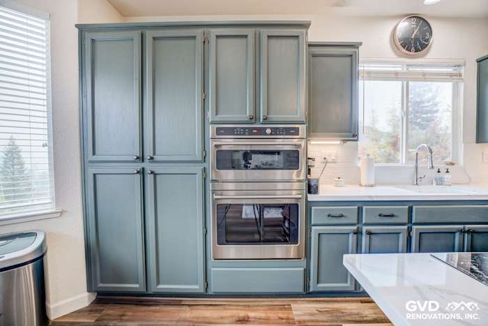 Stylish El Dorado Hills kitchen featuring blue cabinetry, stainless steel appliances, and large windows for natural light