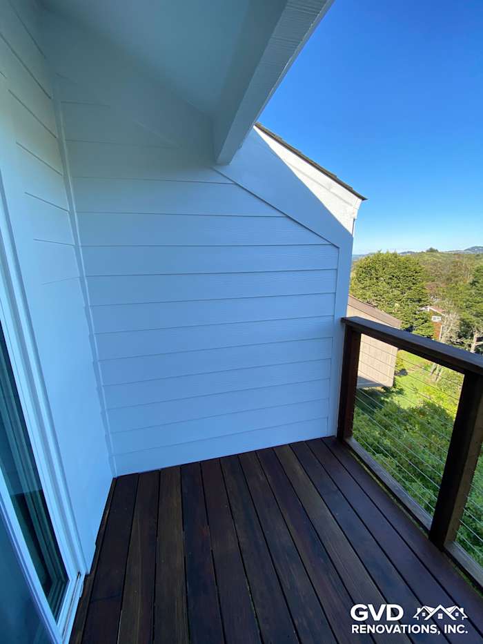 Freshly installed James Hardie lap siding and wooden deck railings on a home exterior in Mill Valley, CA