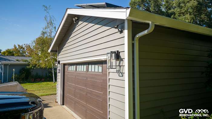 Carmichael home exterior featuring Alside Prodigy Vinyl Siding and new garage door with modern lighting