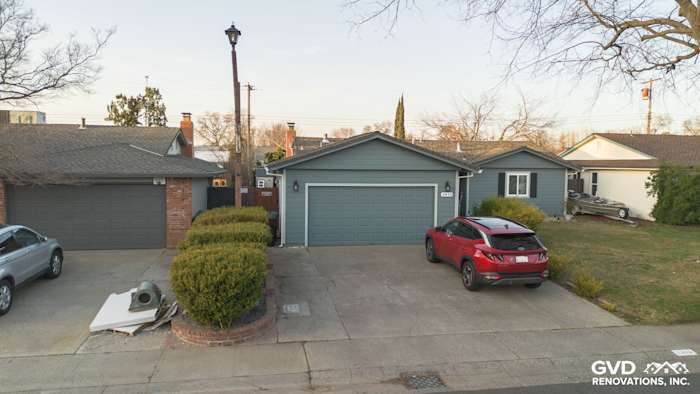Rancho Cordova home featuring Boothbay Blue James Hardie siding, new gutters, and painted eaves