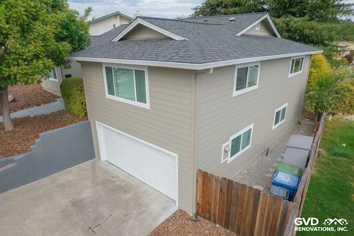 Monterey Taupe James Hardie siding with Arctic White trim on a Petaluma home, featuring Anlin windows and a garage