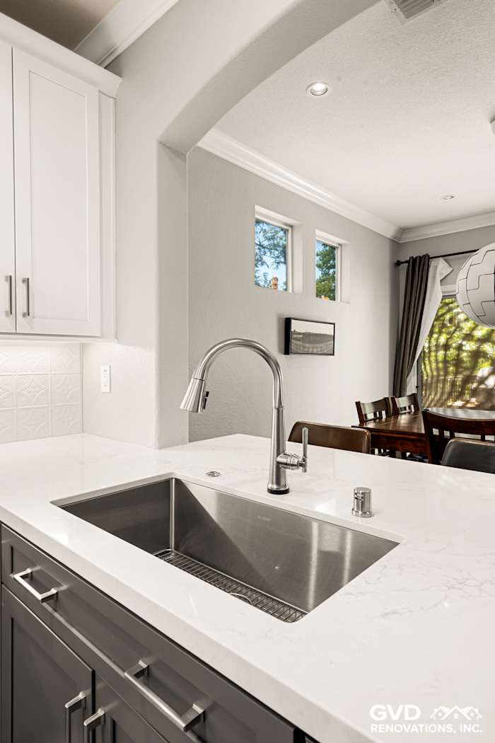 Modern kitchen remodel in Folsom, featuring a stainless steel sink, quartz countertop, and gray cabinetry